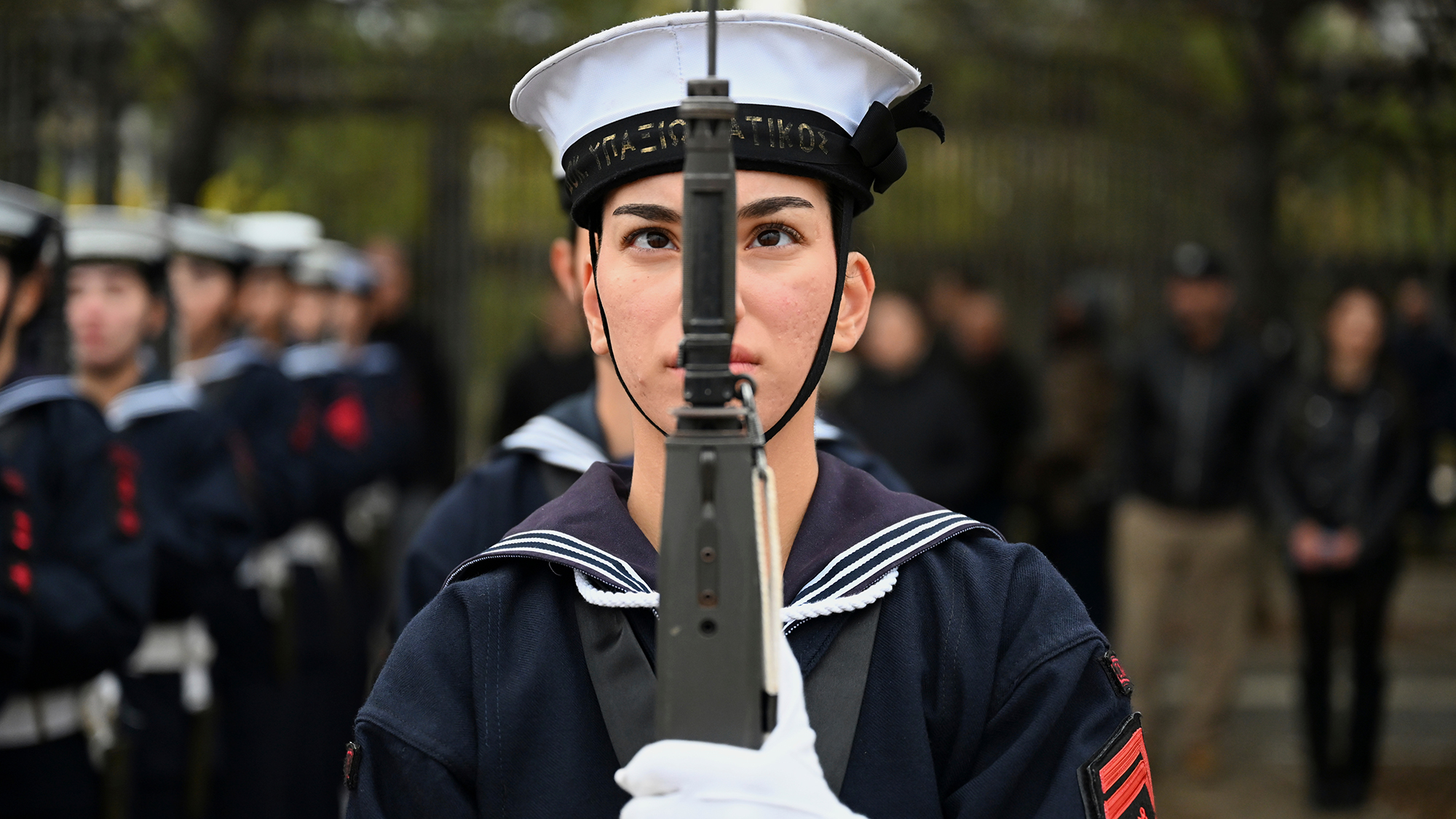 A member of the Greek navy stands in formation ahead of a military parade marking Ochi Day, commemorating Greece's entry into World War II, in Thessaloniki, Greece