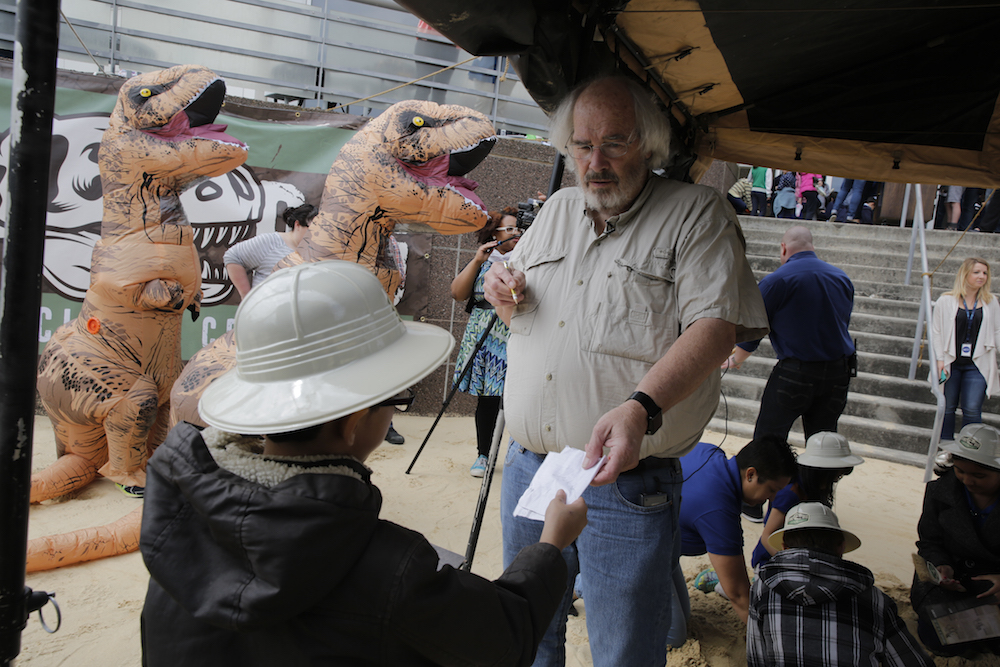 Jack Horner signs an autograph for a young fan.