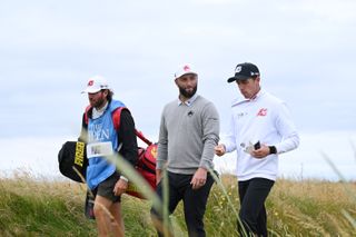 Jon Rahm and David Puig walk together during the 152nd Open Championship at Royal Troon