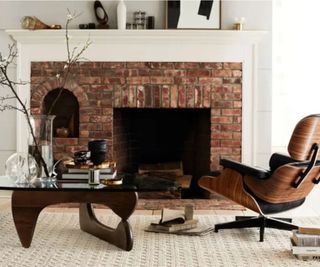 Classic Eame leather swivel chair by a fireplace