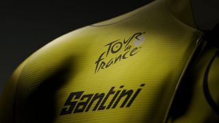 A cryptic close up of a yellow jersey with both the Tour de France and Santini logos visible