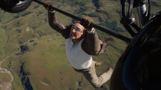 Tom Cruise hangs onto a plane's landing gear in Mission: Impossible - The Final Reckoning.