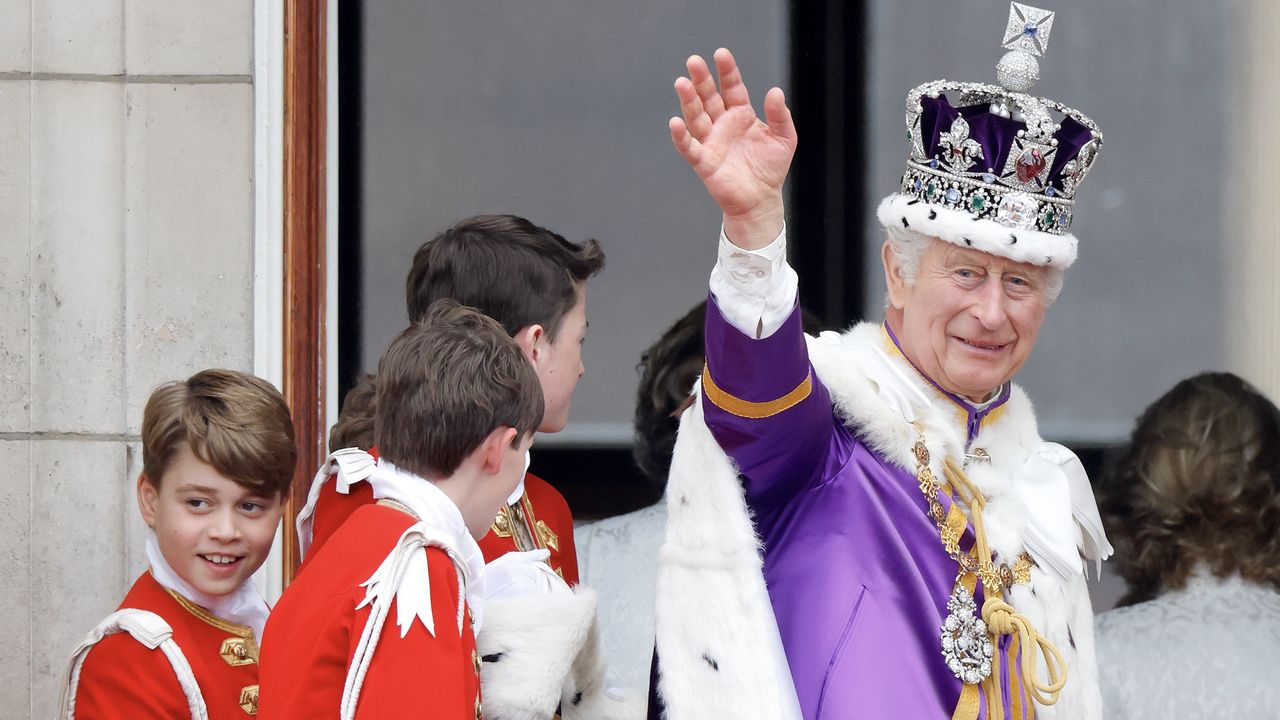 King Charles waves to the crowds alongside members of the royal family including Prince George