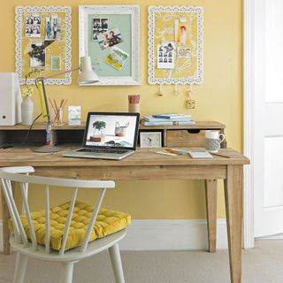yellow wall with wooden table and white chair
