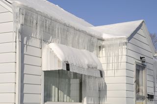 Icicles and snow on white house
