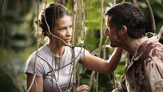 Evangeline Lilly and Josh Holloway sit among vines on an island