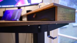 Closeup of the Fezibo Worland standing desk storage drawer and underside hanger, in a home office