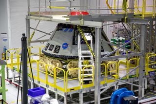 Boeing's CST-100 Starliner spacecraft is pictured back home at the company's Commercial Crew and Cargo Processing Facility, where it is undergoing inspection after its Orbital Flight Test mission in December 2019.
