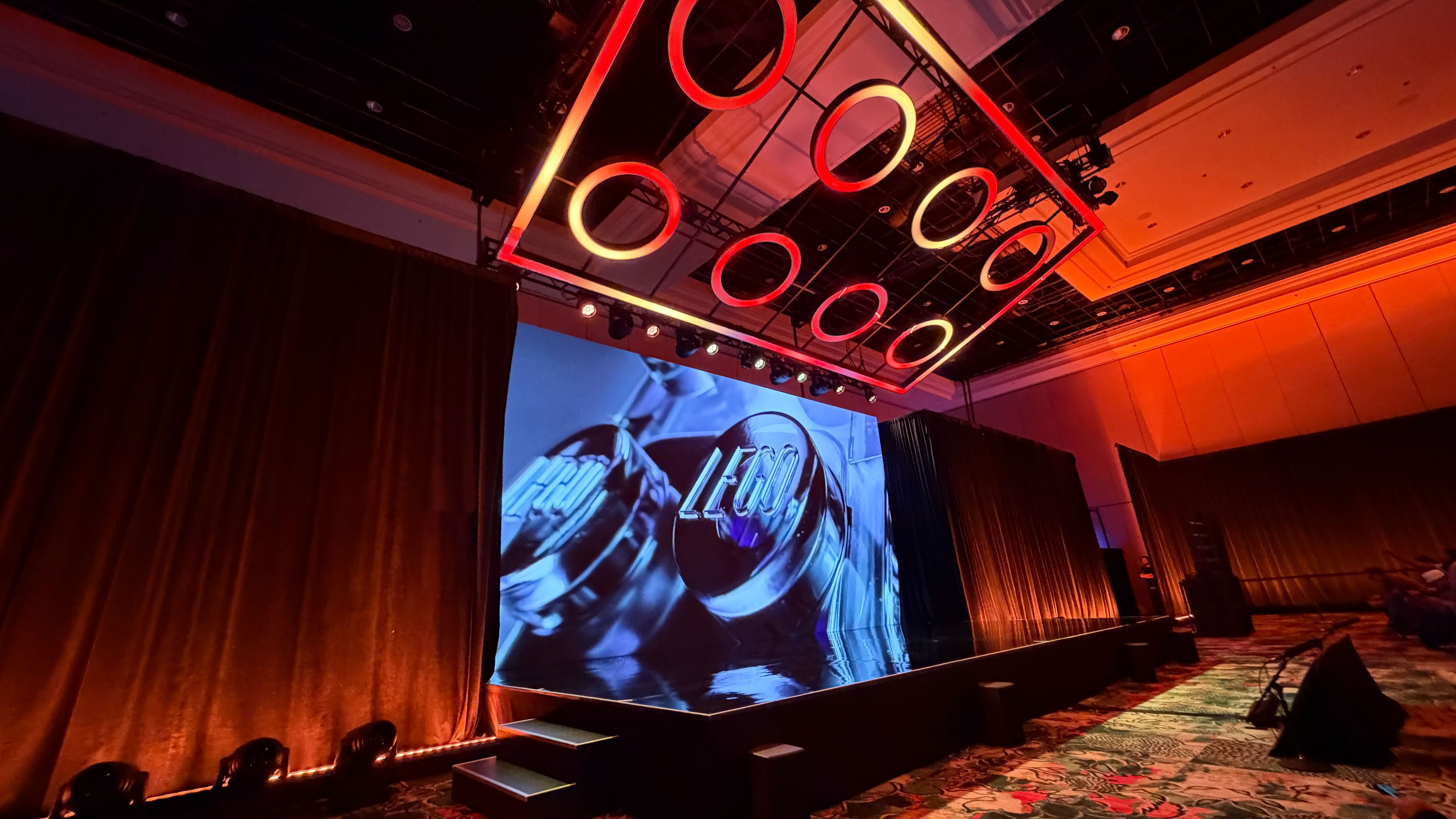 Lego stage at CES showing a brick-logo light and a Lego stamp on a brick peg