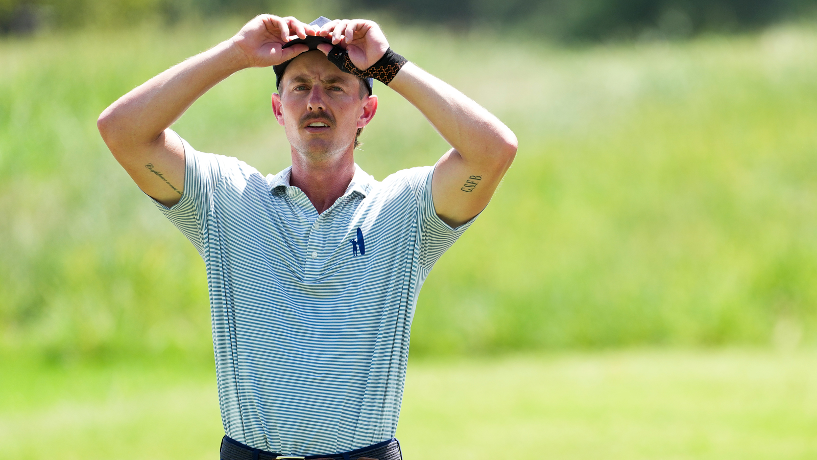 Jake Knapp adjusts his hat