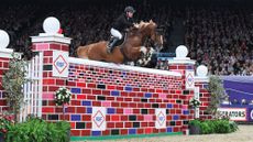Joseph Trunkfield riding Senators Rhondaigo in the puissance competition at HOYS in 2021