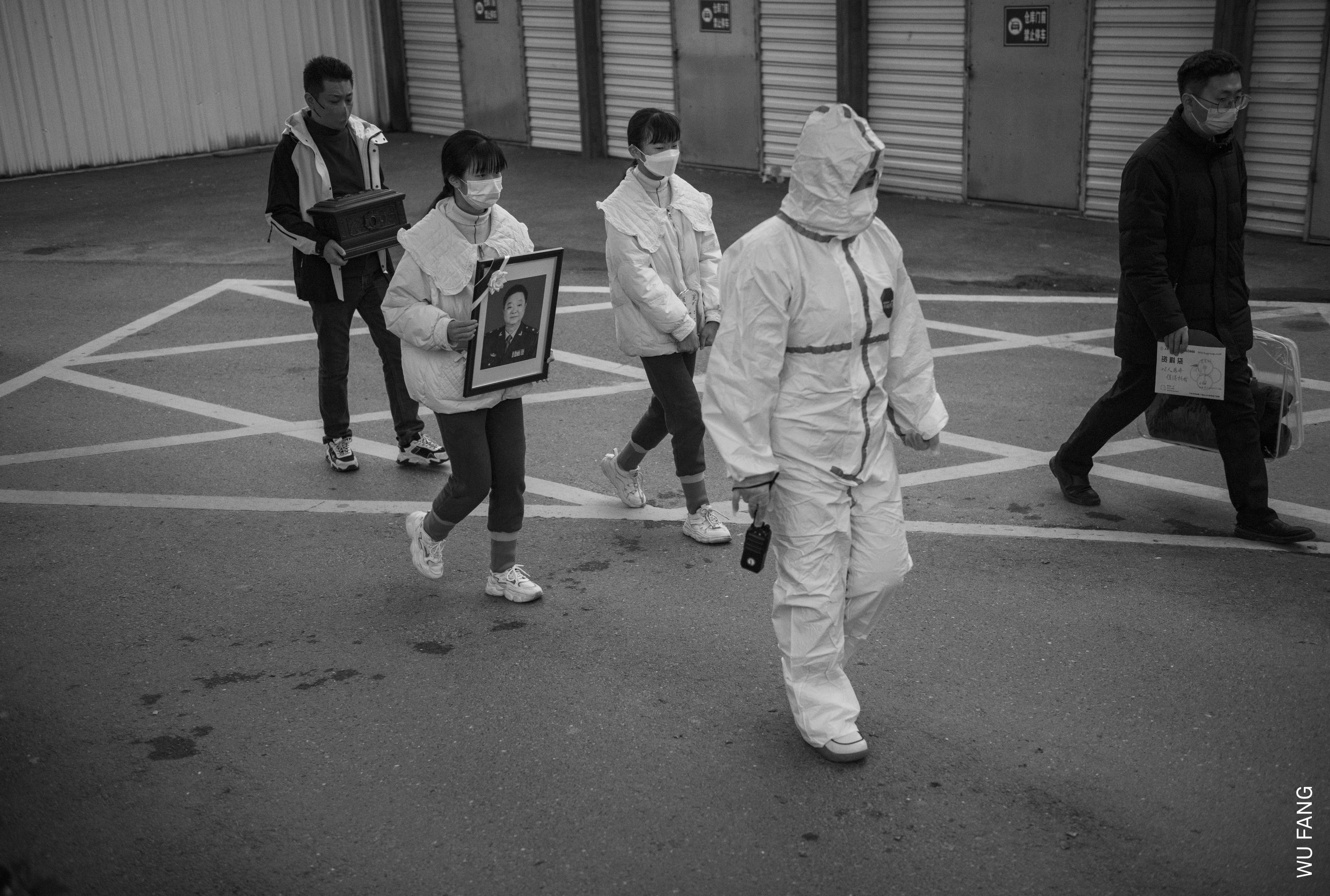 Zhizhi and Huihui carry their father&amp;rsquo;s portrait during his funeral procession. Wu Jingzhou passed away in late 2022, leaving the 72-year-old Sheng Hailin to raise their teenage daughters alone