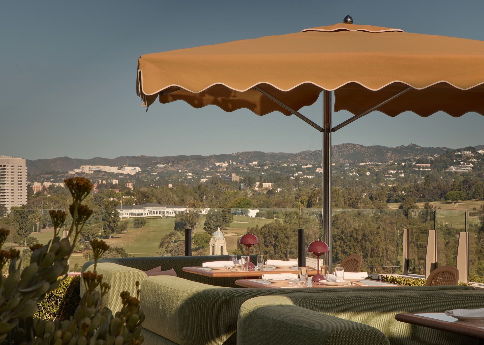 a view of Gemma restaurant with a rooftop umbrella and views of los angeles