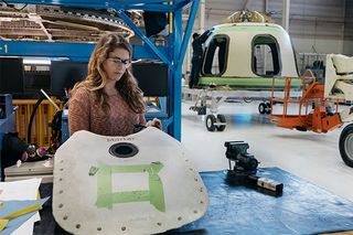 Blue Origin engineer assembles New Shepard parachute cover in the Kent, Washington facility.