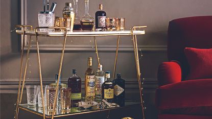 Bar cart next to red armchair