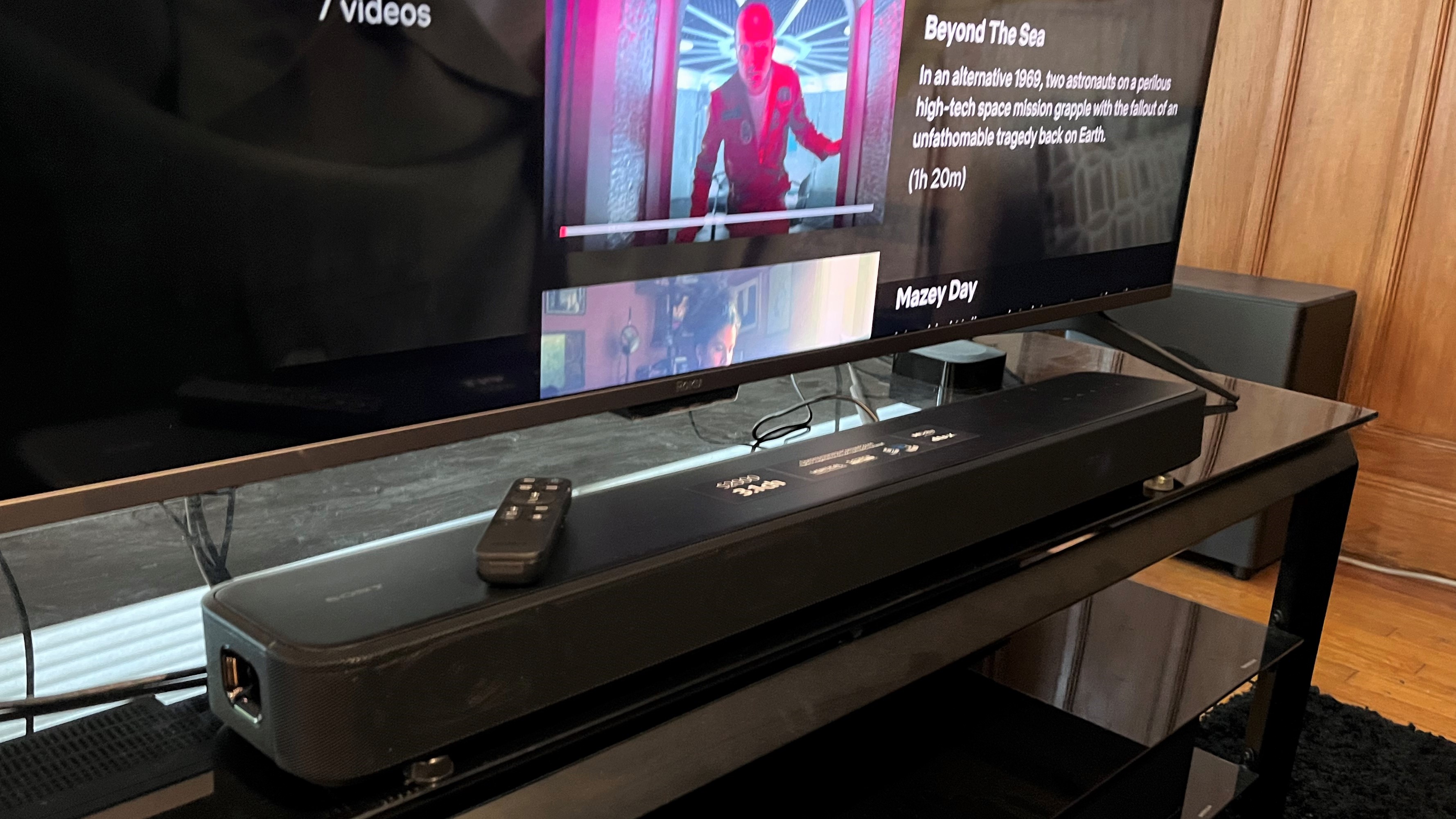 Sony HT-S2000 soundbar on TV stand with Netflix Black Mirror menu in background