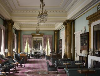 The Athenaeum - Waterloo Place - London SW1. A view down the splendid drawing rom. It has three fireplaces surmounted by enormous pier glasses that reflect the space. Photograph: Will Pryce/Country Life Picture Library.