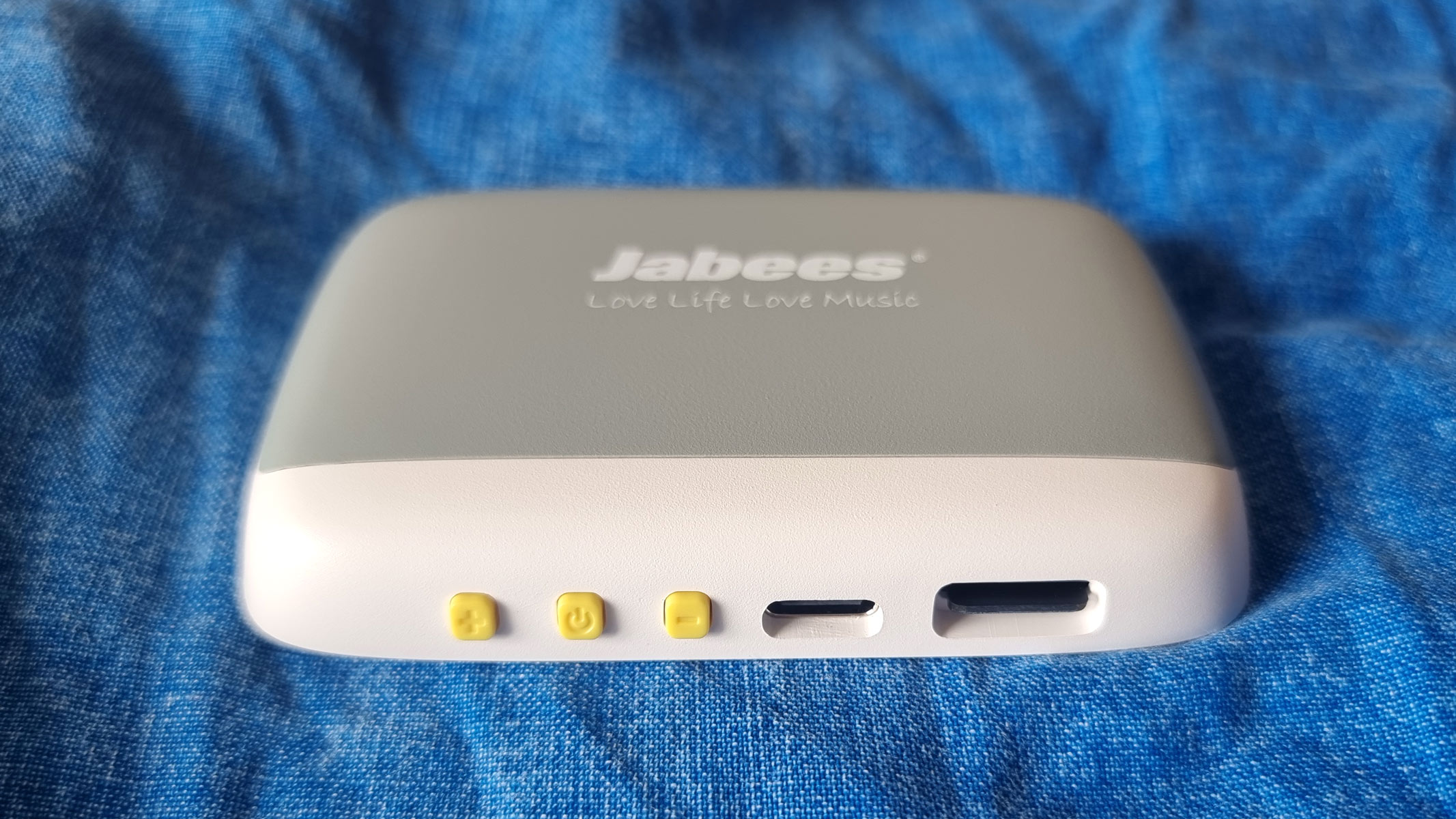a close-up picture of the buttons on the Jabees Peace Pillow Speaker 