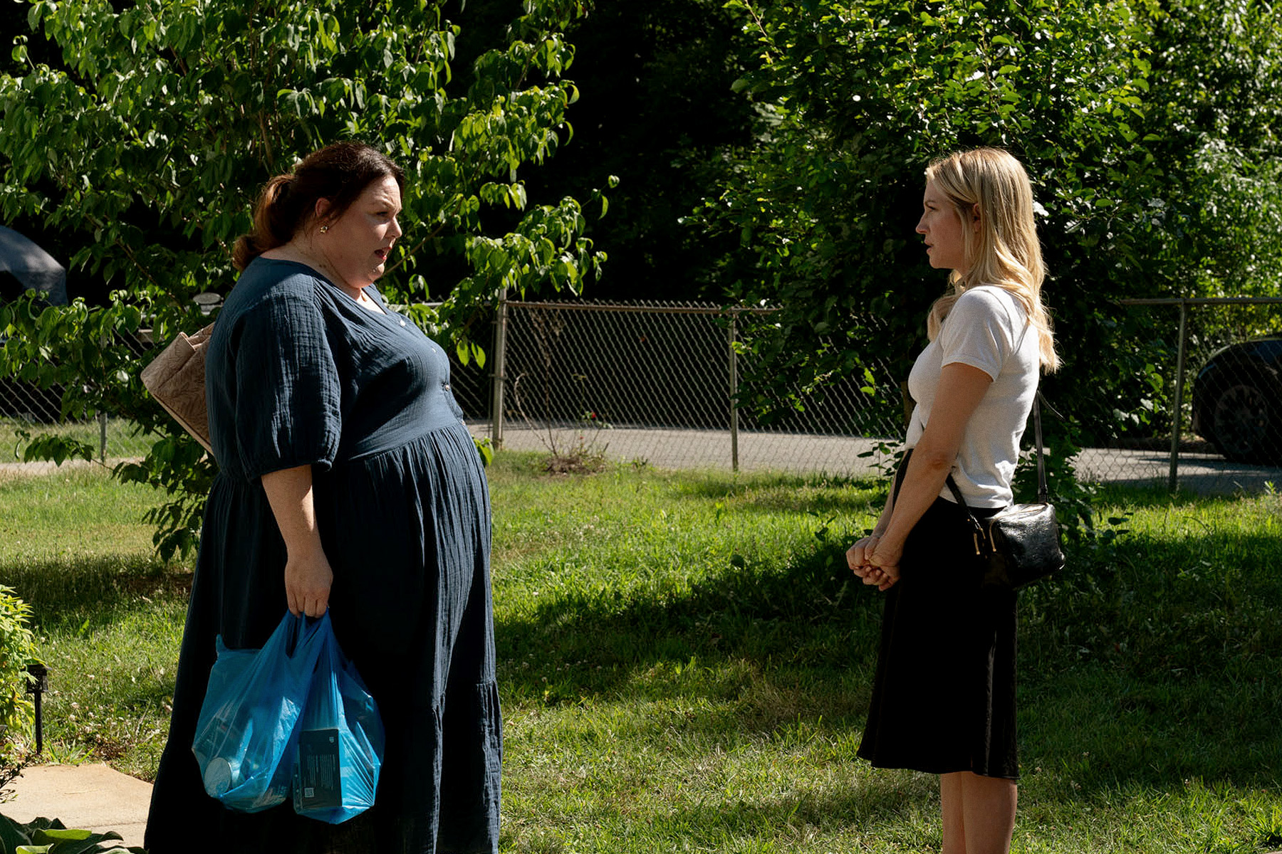 chrissy metz as starr speaking to brittany snow as sophie outside in a still from the hunting wives