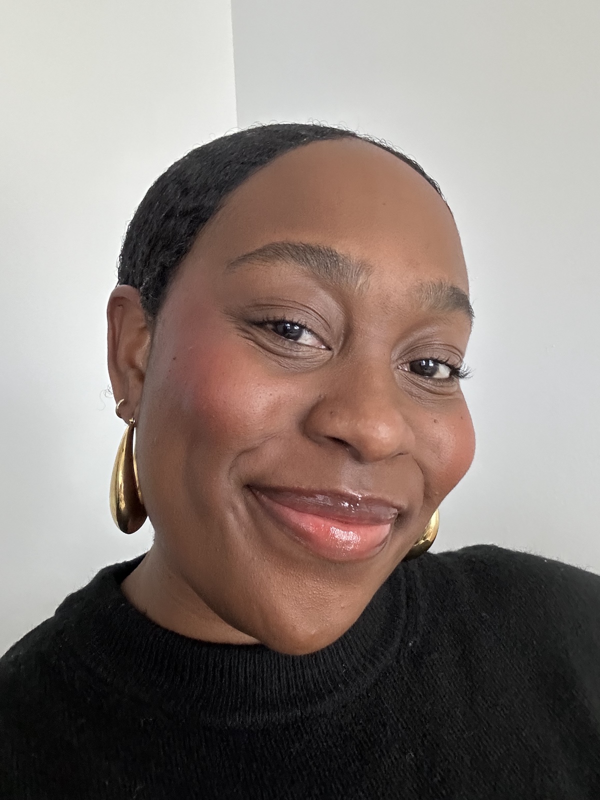 Aniyah Morinia tests Summer Fridays Lip Butter Balm.