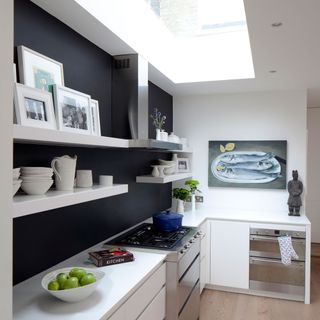 kitchen with white wall and black feature wall behind shelf