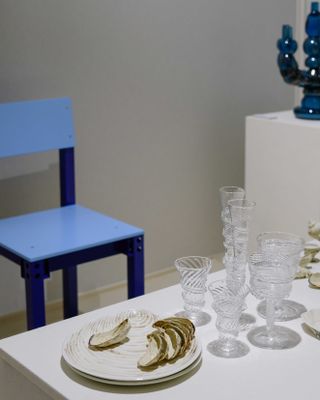 Matter and Shape first edition: blue chair beside table with glassware