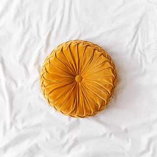 Mustard-colored throw pillow