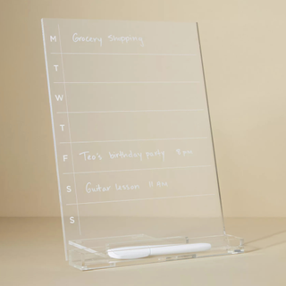 A clear acrylic weekly planner with white font