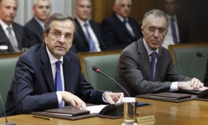 Newly appointed Greek Prime Minister Antonis Samaras attends the first cabinet meeting of the country's new government, which is expected to ask Europe to ease up on harsh austerity demands.
