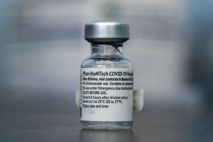 A vial of Pfizer Covid-19 vaccine seen at a vaccination centre in London