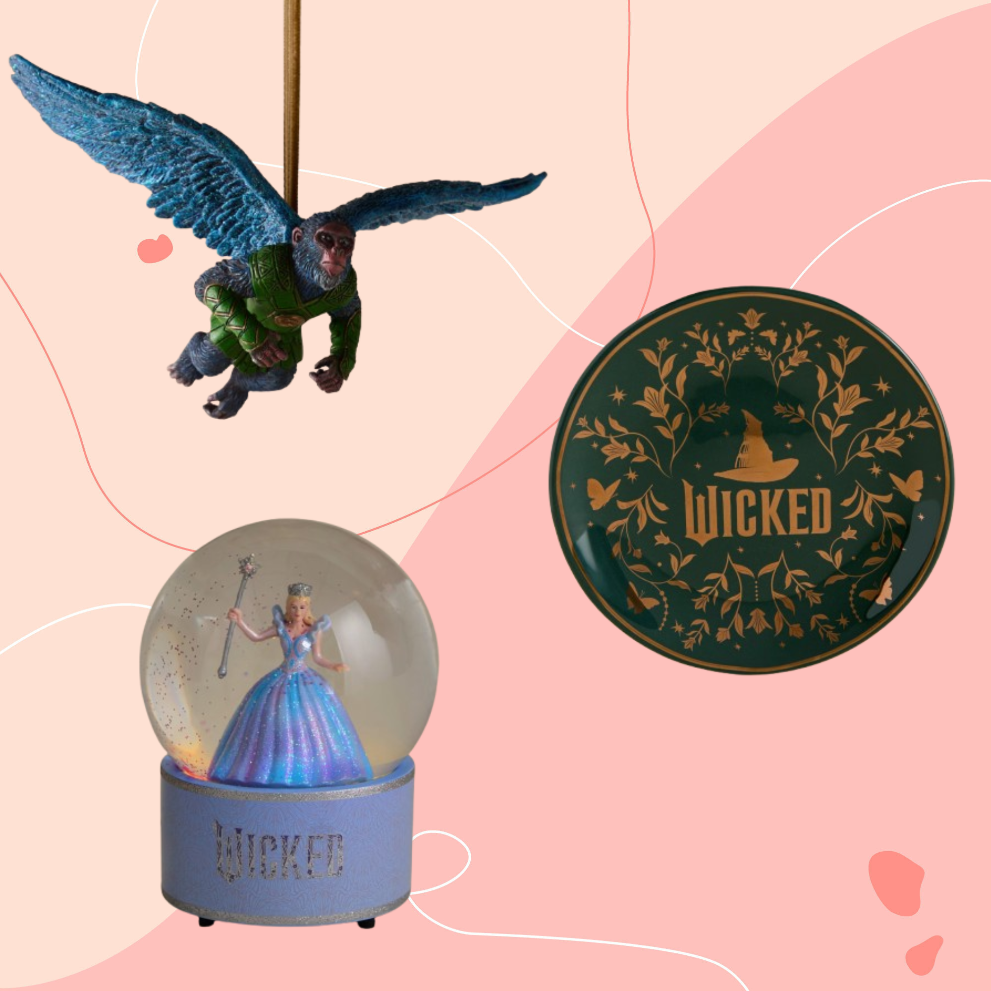Wicked flying monkey, trinket dish and snow globe on a pink background