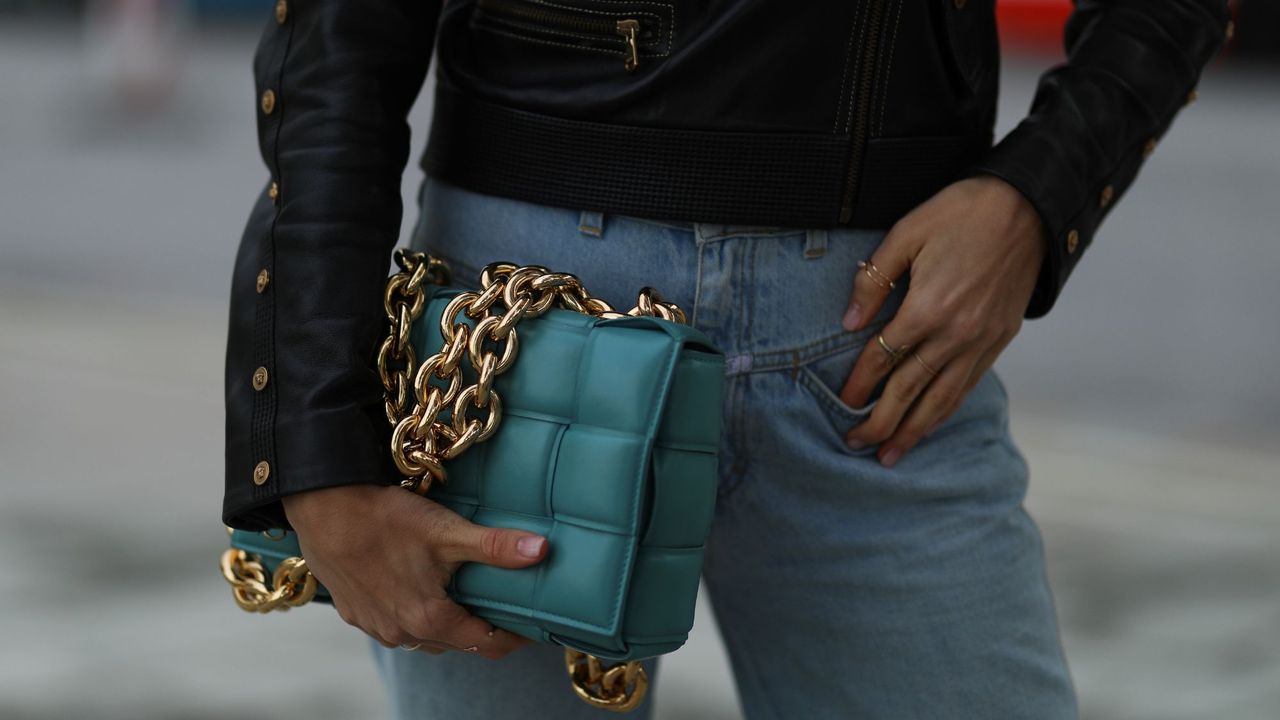 a woman holding her handbag - lipgloss nails