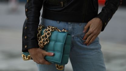 a woman holding her handbag - lipgloss nails