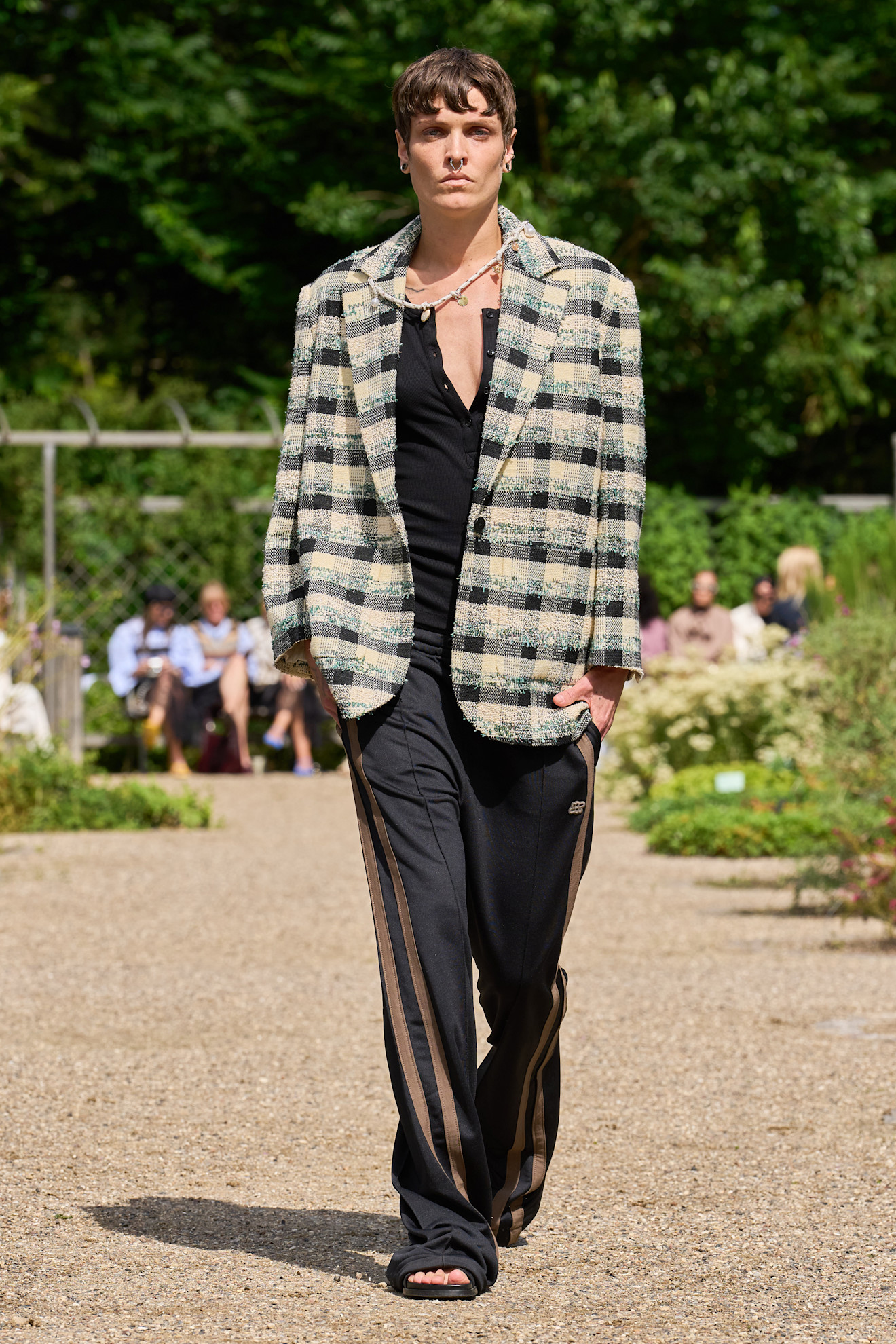 Model wears check tartan prints on spring and summer 2026 runway