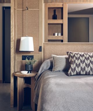 a bedside table with a bedside lamp and storage areas in a room at The Royal Senses