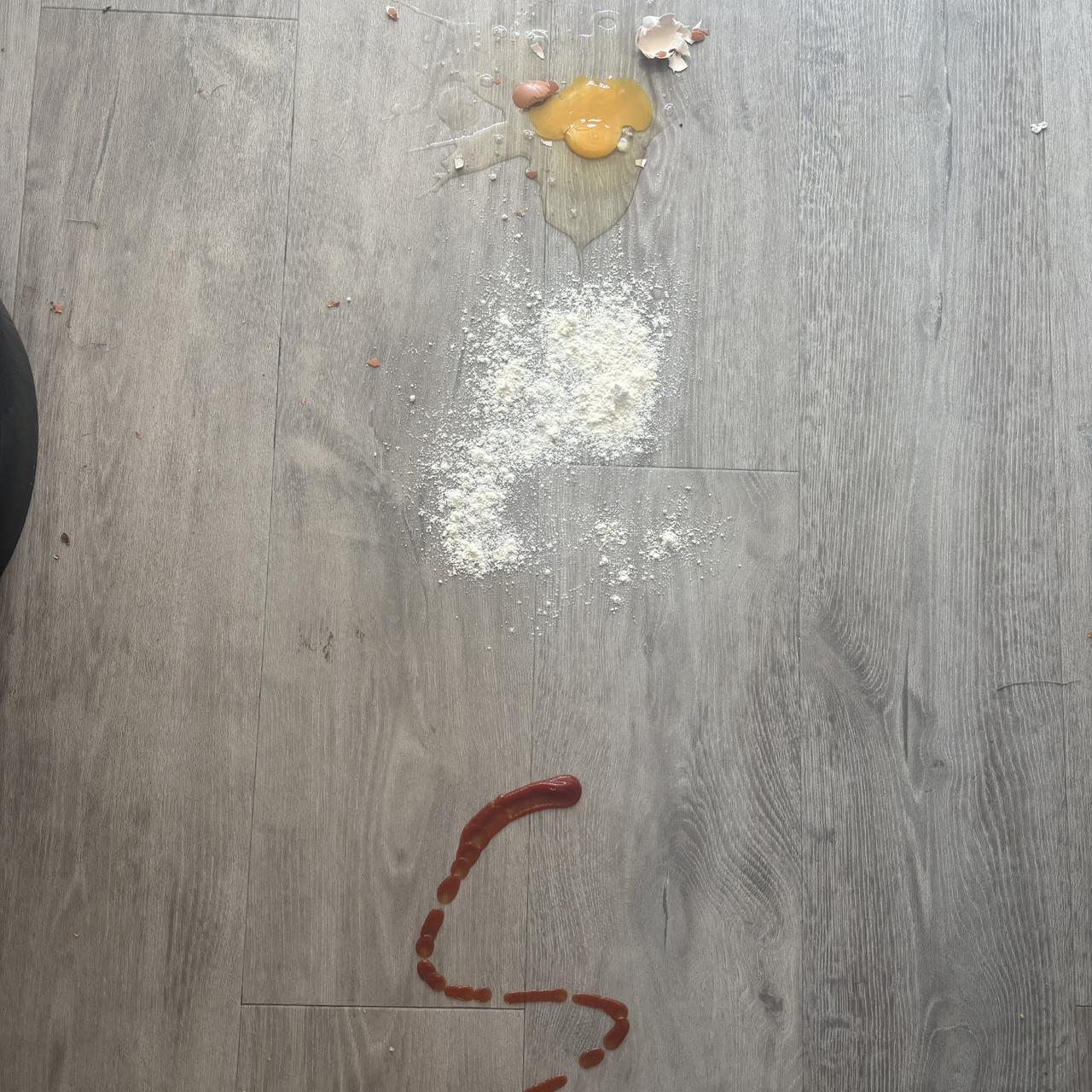 egg, flour and ketchup spills on hard floor