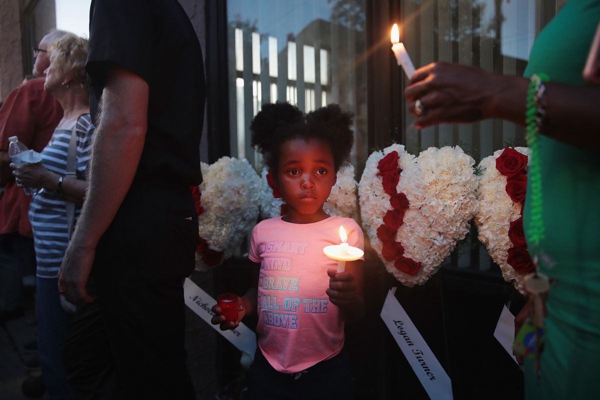 Six-year-old Mariah attends a memorial service with her mom in Dayton, Ohio, to recognize the victims of a mass shooting in the Oregon District there on Aug. 04, 2019.