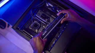 Intel Arc A750 graphics card being installed into a gaming PC