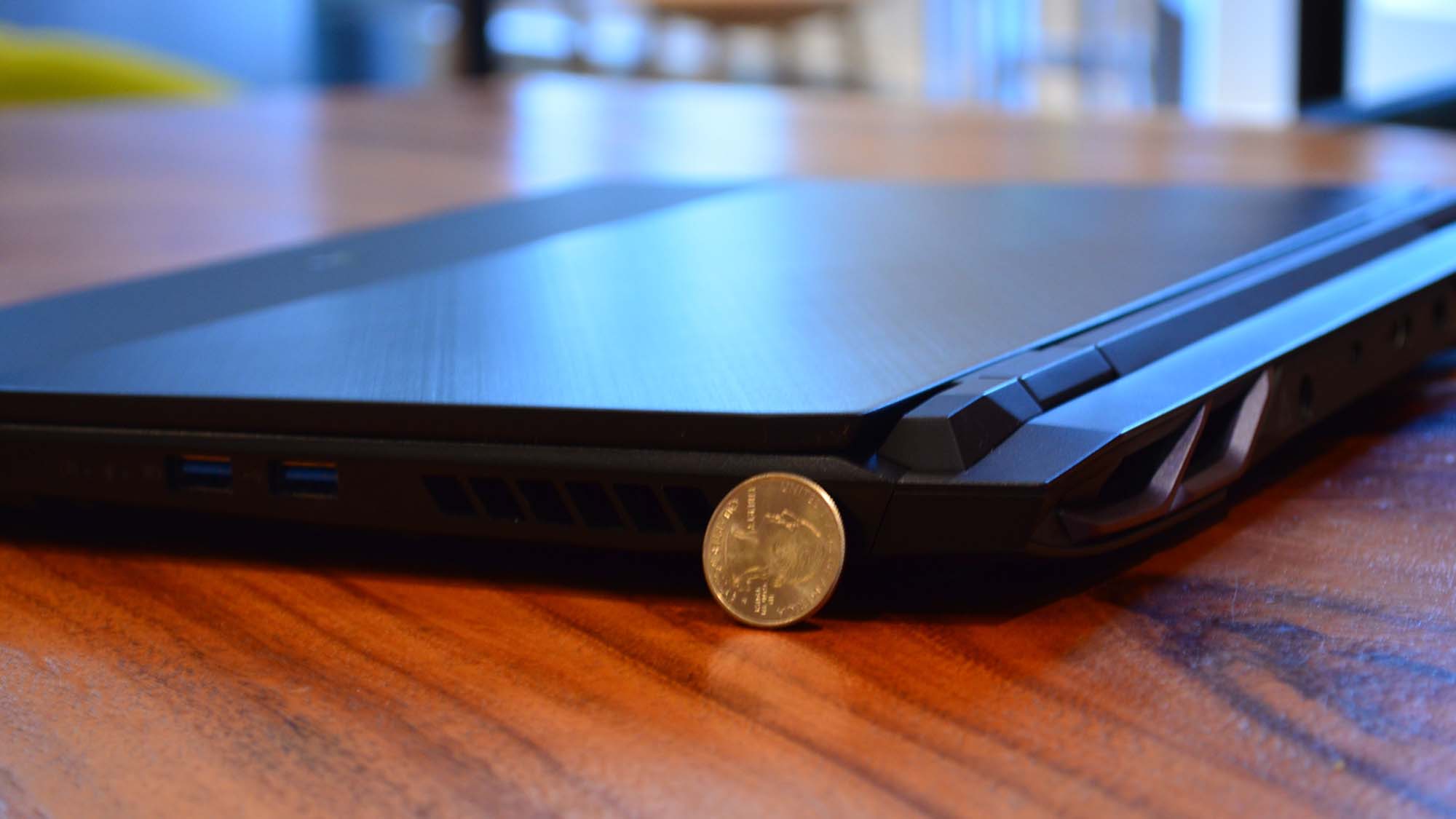 An Acer Predator Helios 300 (2022) sitting on a wooden table in a commissary