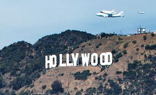 Photographer Olivia Hemaratanatorn captured this view of space shuttle Endeavour soaring over the famed Hollywood sign during its low flyover of Los Angeles on Sept. 21, 2012.