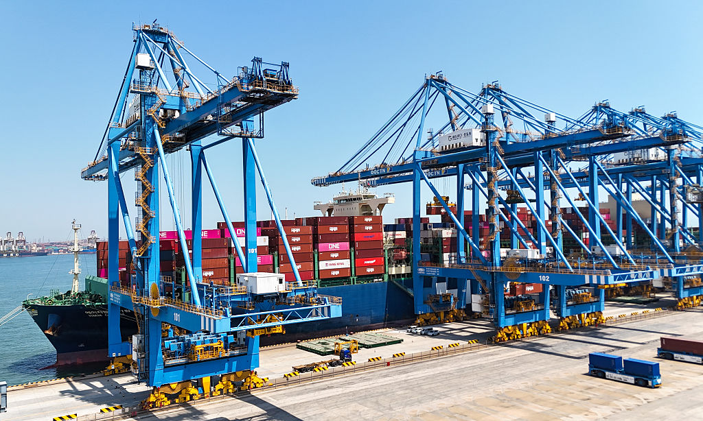 A cargo ship loads and unloads goods