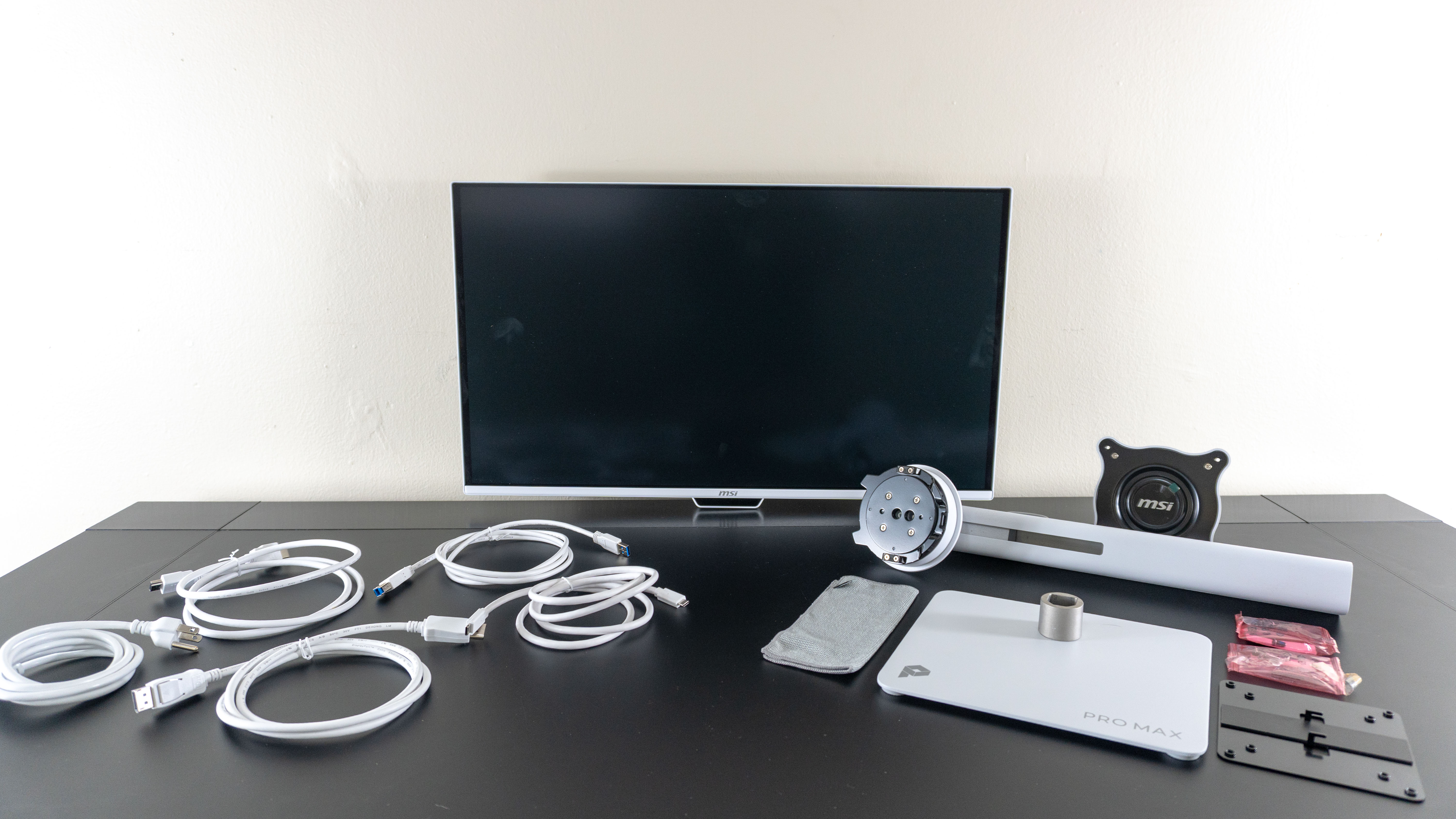 The MSI Pro Max 271UPXW12G monitor unboxed on a desk
