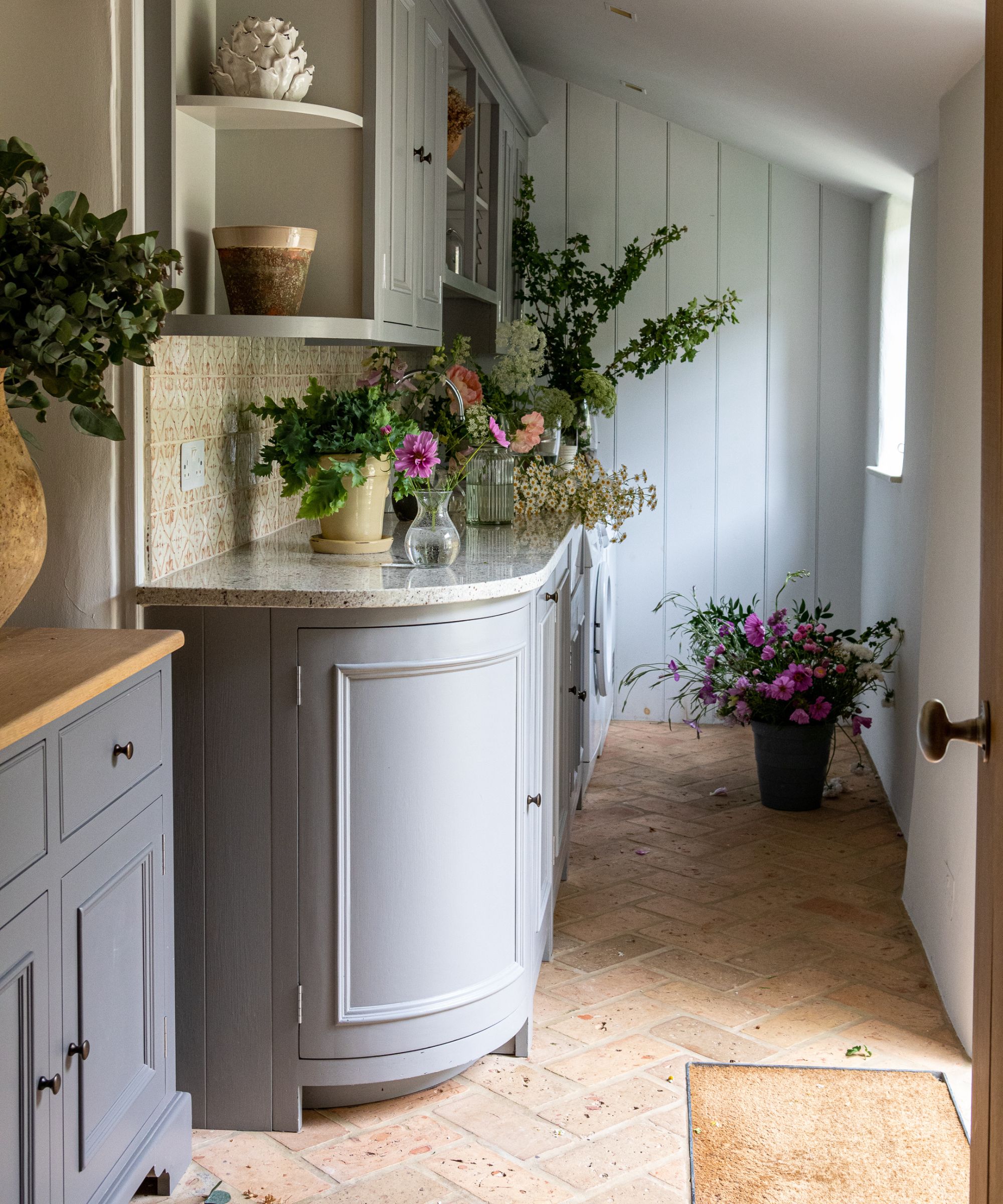 Mudroom with tiled floor and built-in furniture