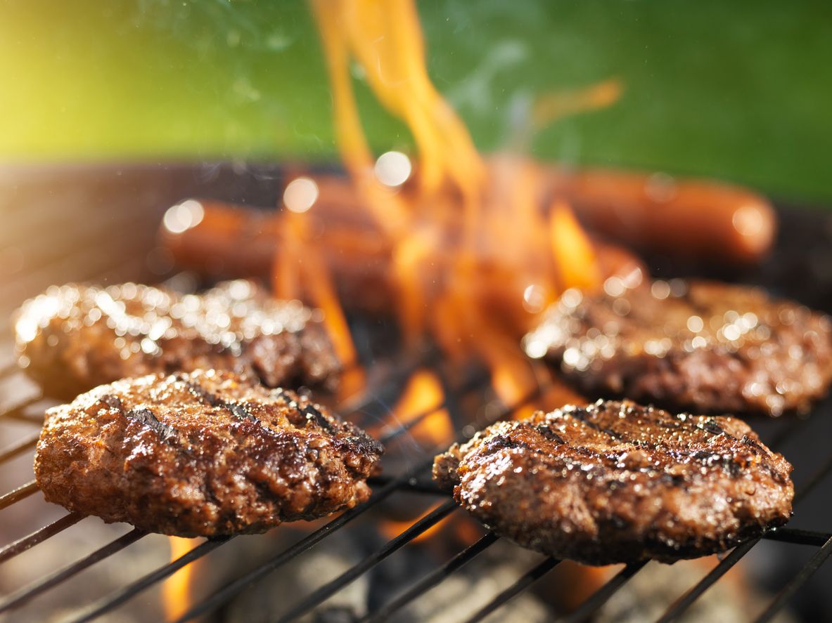 Burgers and hot dogs on a grill. 