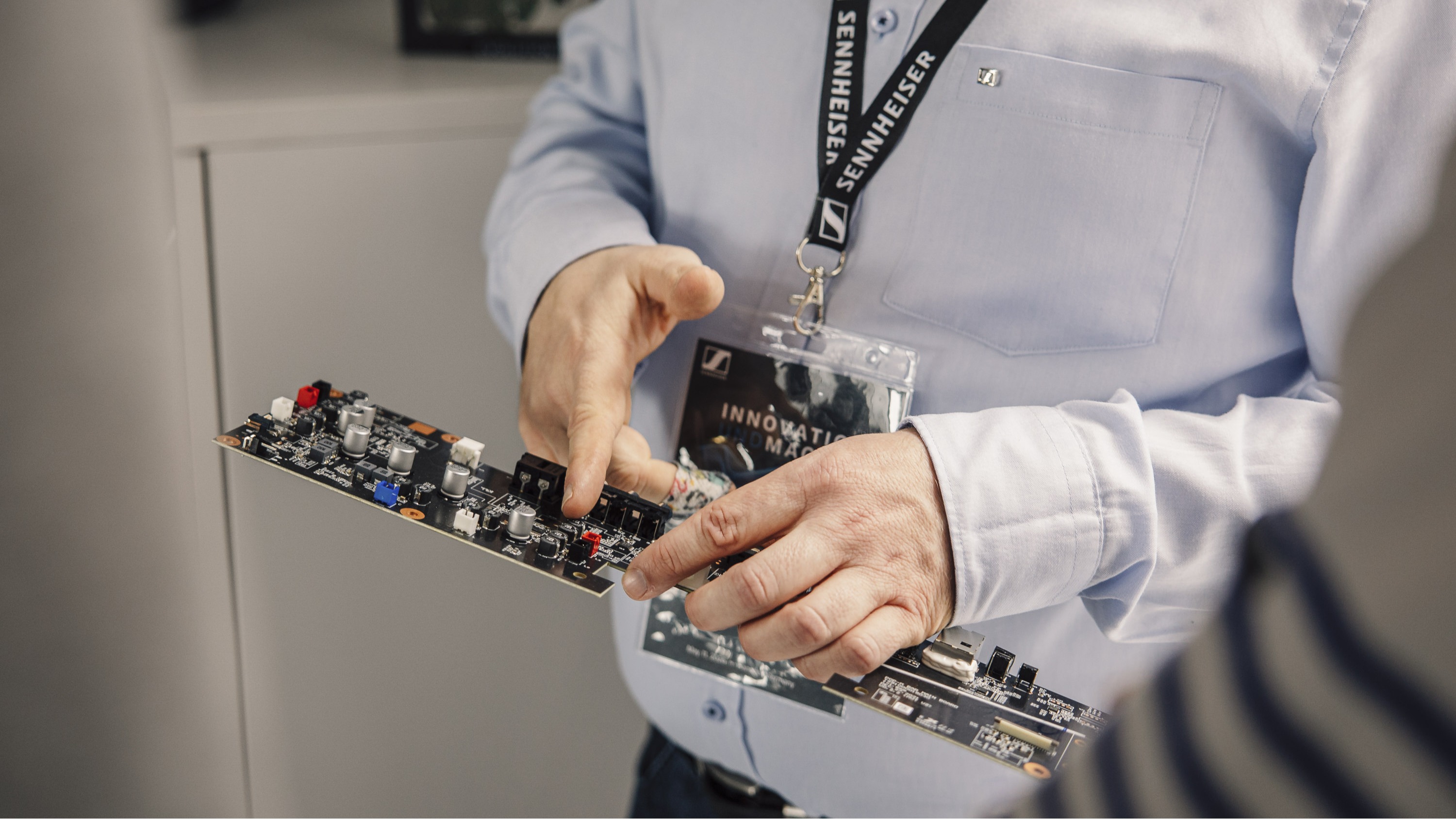 Sennheiser engineer holding a circuitboard