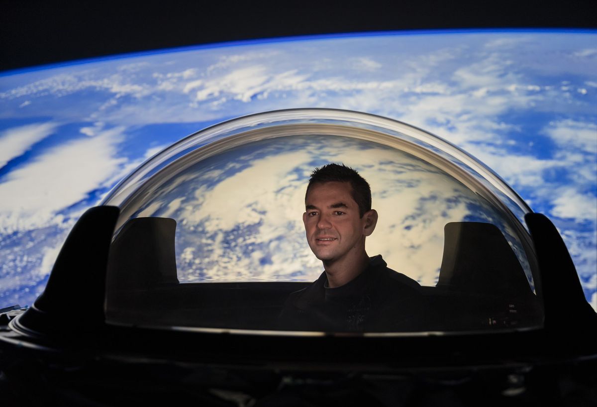 Billionaire Jared Isaacman, the financier of SpaceX&#039;s Inspiration4 private spaceflight, poses with inside the Dragon Cupola window that will be used on the historic all-civilian space mission.