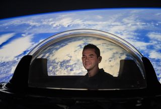 Billionaire Jared Isaacman, the financier of SpaceX's Inspiration4 private spaceflight, poses with inside the Dragon Cupola window that will be used on the historic all-civilian space mission.