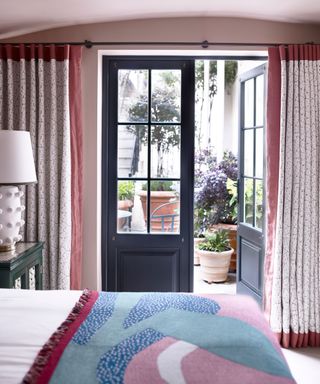 Window treatment idea with floor length curtains in a bedroom