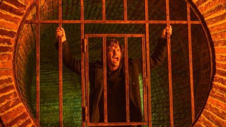 Jeremy Irvine as James Sunderland, screaming on the other side of a gate in Return to Silent Hill