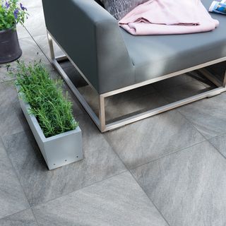 slab paving with grey sofa and pink towel